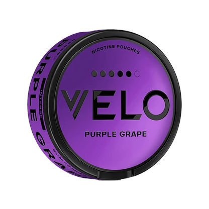 A round can of VELO Purple Grape nicotine pouches, featuring a metallic purple lid with black branding and a black rim, set against a plain white background.